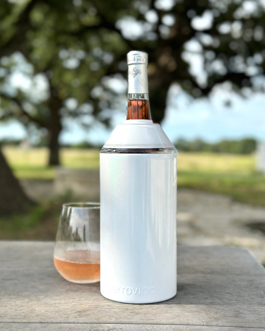 Wine & Champagne Chiller keeping bottle cool outdoors on a table.